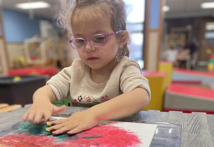 cfi-student-smiling-finger-painting_2